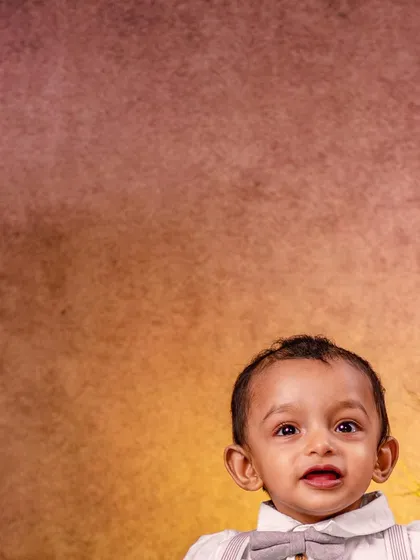 A close-up portrait from the rustic woodland session, focusing on this toddler's bright, engaging eyes and happy expression. These shots are perfect for capturing the little details you never want to forget.