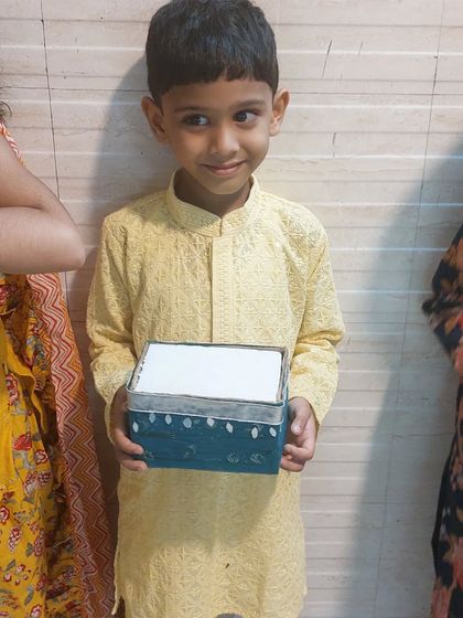 Another happy student with his decorated box, ready to be used for Janmashtami celebrations. The pride in their creations is always wonderful to see.
