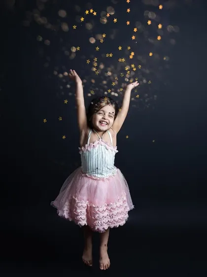 Throwing glitter in the air with a huge smile! These action shots are full of energy, joy, and a little bit of magic.