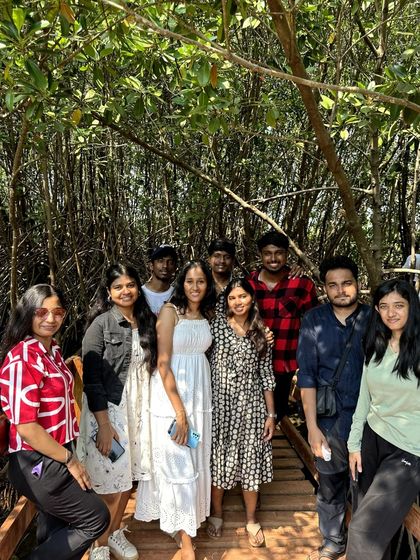 A group photo on the wooden boardwalk through the mangrove forest in Honnavar.