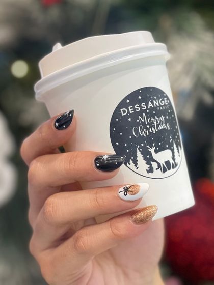 A closer look at our festive nail art, combining sparkling gold, deep black, and a touch of white for a chic holiday manicure.