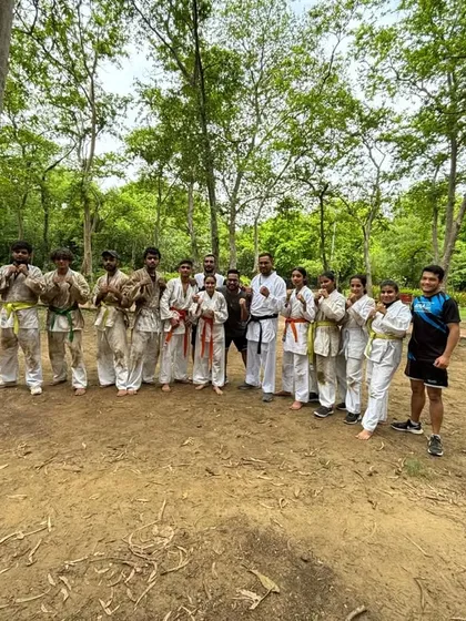 A group of our students after their outdoor belt test. Training in different environments builds adaptability and resilience.