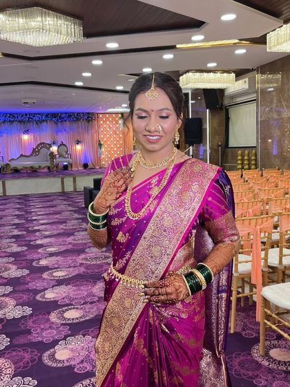 A stunning Maharashtrian bride in a vibrant purple saree. Her wedding look is uniquely hers, radiating grace and confidence in every detail.