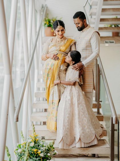 Another shot of my family on the stairs. My daughter is looking up at me, and the love between us is palpable. Our coordinated outfits make the moment even more special.