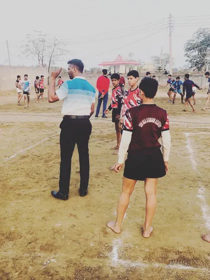 Coaching is about teaching and guiding. Here I am on the ground, instructing our young players on the fundamentals of the game.