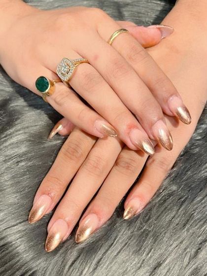 A luxurious take on the French manicure using gold chrome for the tips. These stiletto nails are perfect for parties and special events.