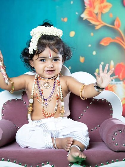 A playful little Krishna with a flute, ready to charm everyone with his smile.