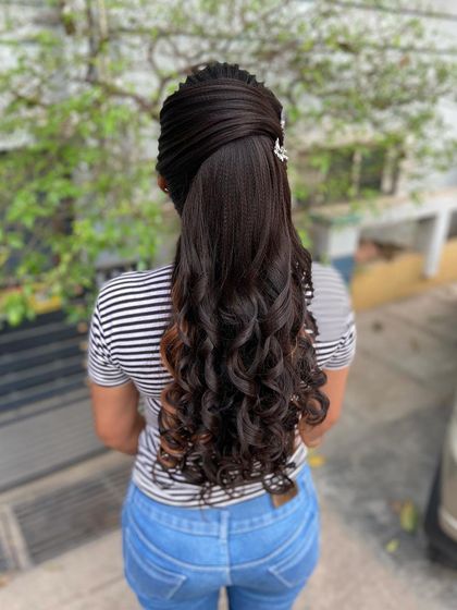 Another view of the advanced ponytail, showing the intricate texturing and shaping at the crown for a high-fashion look.