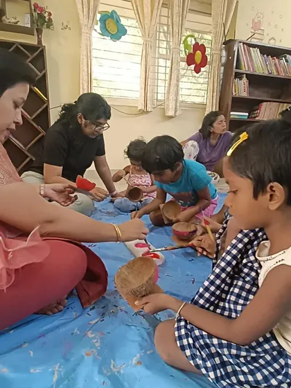 A close up of the coconut shell painting in progress. This activity uses natural materials and encourages resourcefulness.