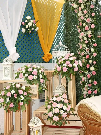 A close-up of the decor for an intimate wedding. We used wooden crates, lanterns, and beautiful pink and white floral arrangements to create a charming and rustic corner piece.