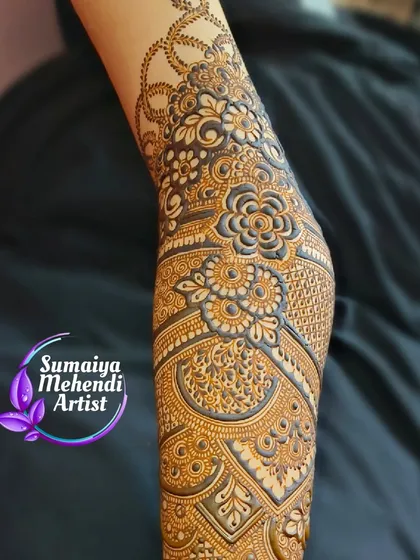 A close up of the arm from a full bridal set. The floral patterns are shaded to create depth, and the leafy vine wraps beautifully around the arm.