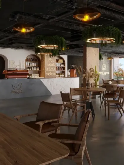 This view shows the overall layout of the cafe, with its open-plan design and various seating options. The exposed ceiling and industrial elements are softened by the abundant use of plants.
