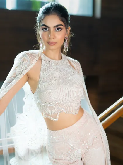 A closer look at the exquisite detailing on this Mishru outfit. The combination of the halter top and cape creates a look that is both elegant and on-trend for the modern bridesmaid.