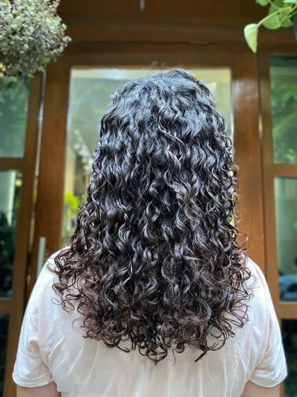 This client from France came in with dry, undefined curls. After a deep conditioning treatment and a precision haircut, her hair was revitalized, hydrated, and full of life.