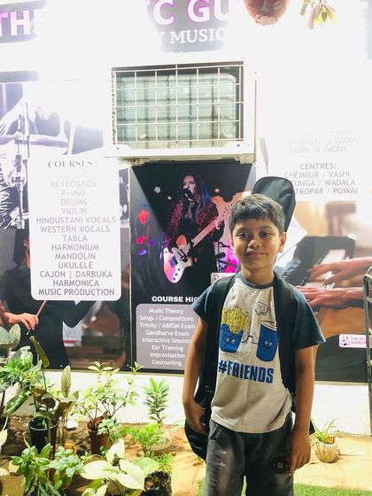 A young guitarist ready for his class. Our centers are designed to be welcoming spaces where students feel excited to come and learn.