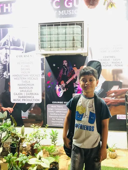 A young guitarist ready for his class. Our centers are designed to be welcoming spaces where students feel excited to come and learn.