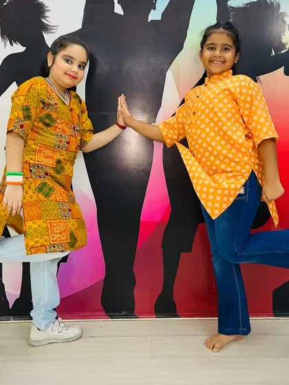 Dressed in the colors of the flag, these students share a high-five, celebrating both friendship and national pride.