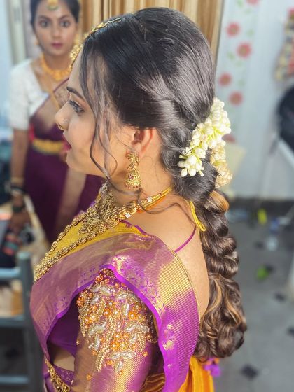 Another angle of the romantic side-swept curly hairstyle, perfect for a reception.