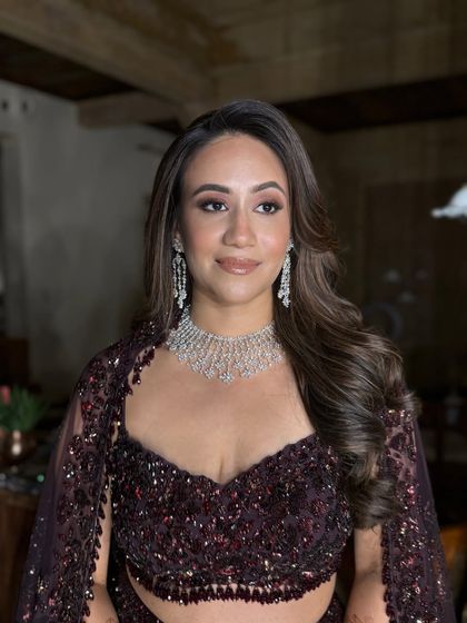 This portrait showcases the complete look in a different lighting. The makeup remains flawless and radiant, proving its durability and photogenic quality throughout the night.