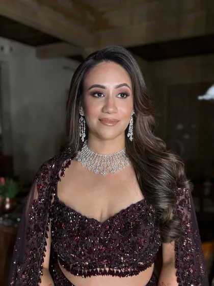This portrait showcases the complete look in a different lighting. The makeup remains flawless and radiant, proving its durability and photogenic quality throughout the night.