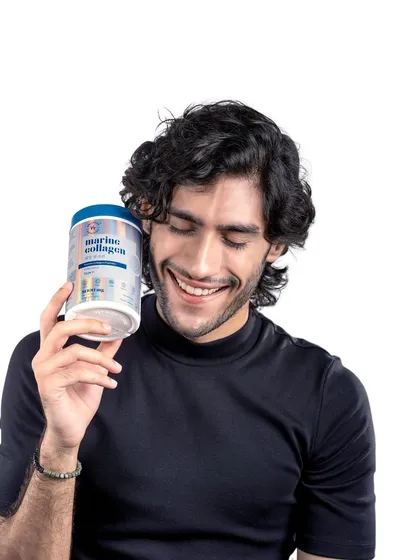 A lifestyle portrait of a male model with the marine collagen product. This image helps the brand connect with a broader audience, showing that wellness and skincare are for everyone.