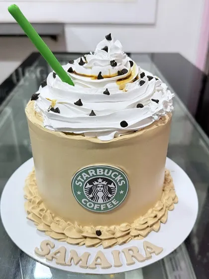 A Starbucks Frappuccino cake for a coffee lover. We recreated the iconic drink with whipped cream, chocolate chips, and the green straw, all in cake form.