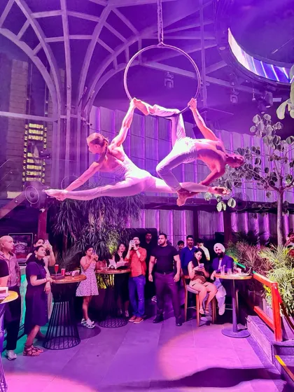 A beautiful moment from a duo performance on the aerial hoop. This kind of synchronized work relies on both artists having a deep understanding of their flexibility and control, especially in poses like this shared split.