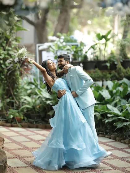 We believe in capturing the quiet, playful moments just as much as the grand ones. This romantic dip amidst a lush garden setting showcases the beautiful chemistry of our couple during their pre-wedding brunch.