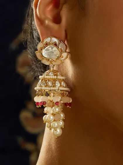 A close-up of the stunning lotus-motif jhumkas with pearl clusters, as worn by Sargun Mehta.