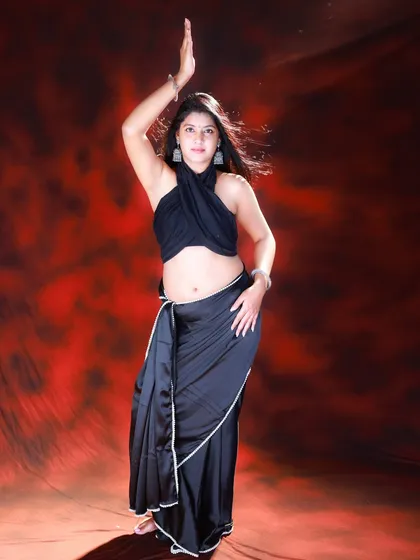 A classic, statuesque pose that highlights the model's form and the elegant drape of the saree.