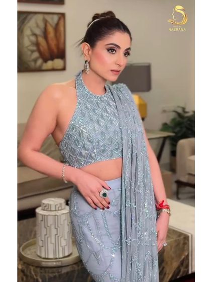 The front view of the knot bun, showing how it creates a chic and sophisticated profile that highlights the neckline and earrings.