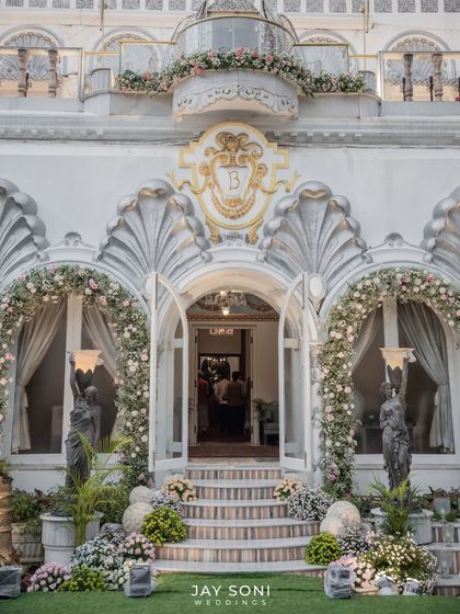 The entrance to this stunning home was transformed into a work of art. I framed the baroque-style doorway with lush floral arches, creating a grand and romantic welcome for the wedding guests.