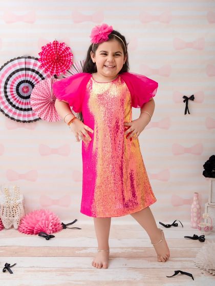 A playful pose from this little girl, showing off her shimmery dress and fun personality.