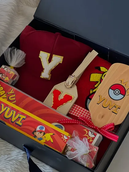 A look inside the Pokémon 'Box of Happiness'. I included a personalized cap with the initial 'Y', a custom luggage tag, and a themed crayon box.