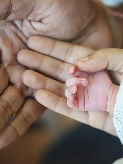 Sometimes, the smallest details hold the biggest love. This close up shot shows a newborn's tiny hand resting in their parent's palms. It’s a powerful reminder of how small they are in these first few days, a memory you will cherish forever.