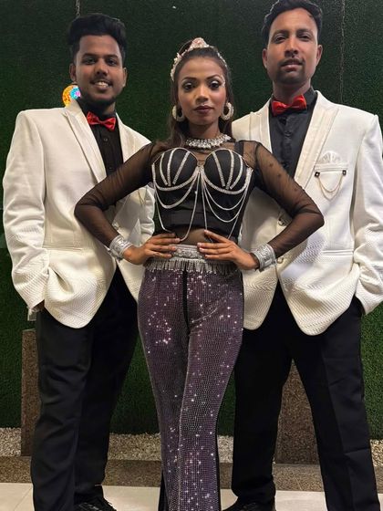 A trio from our team in a stylish black, white, and silver costume combination. We offer various looks to match your event's aesthetic.