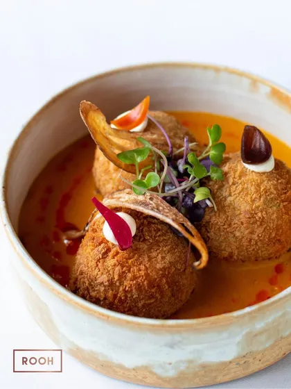 A bowl of our Tofu & Edamame Kofta. The crispy exterior gives way to a soft, flavourful interior, creating a wonderful textural contrast.