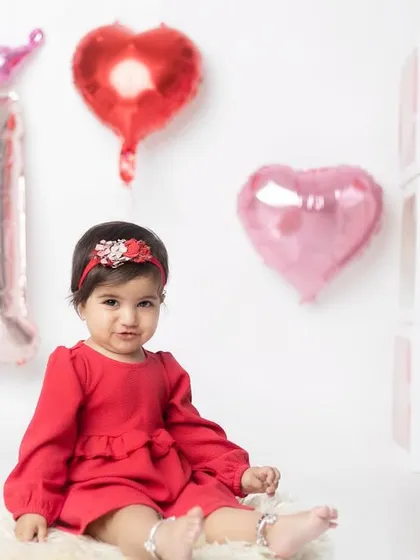 A classic portrait from her first birthday shoot, looking so sweet and innocent in her red dress.