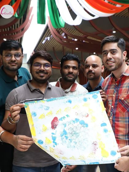 A group proudly displays their finished block printing creation. We love seeing our guests connect and create together during our workshops.