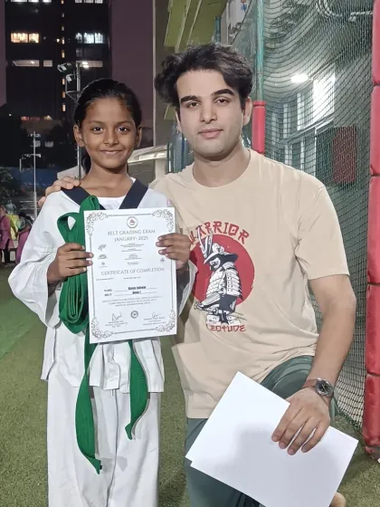 Another student celebrates her promotion. Her consistent effort in class has clearly paid off.