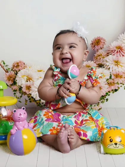 A candid shot of a laughing baby surrounded by her favorite toys. I always encourage bringing personal items to make the child feel comfortable and capture their true personality.