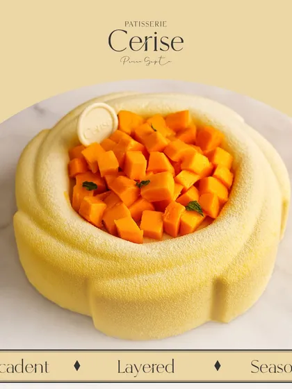 My La Mangue Royale, filled with fresh, seasonal mango. It features layers of mango compote, vanilla mascarpone mousse, and a crunchy crumble.