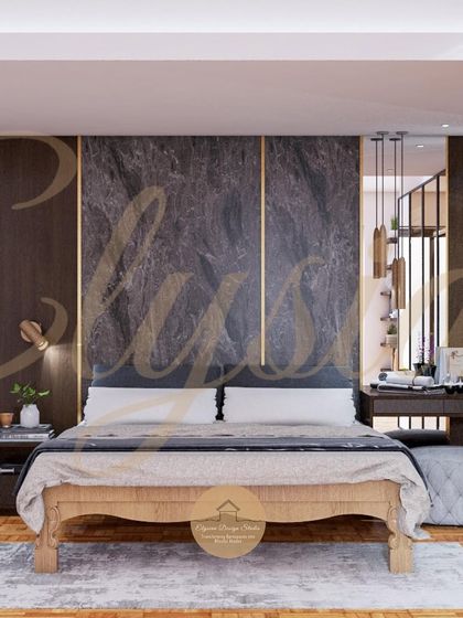 The centerpiece of this bedroom is the custom bed, but the background shows the integrated dressing area and wardrobe. The dark marble-like panel with brass inlays behind the bed adds a layer of opulence.