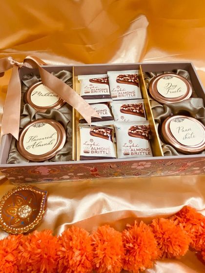 Another angle of our patterned box, showing the neatly arranged almond brittle and decorative jars.