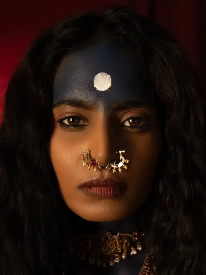 A striking close-up from the 'Kali' series. The composition is centered on the bindi and the powerful gaze, with the dark makeup and traditional nose ring creating a portrait of divine intensity.