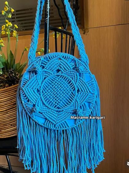 A beautiful example of a macramé bag, showcasing the intricate knotting techniques that differentiate it from crochet. We love working with both art forms.
