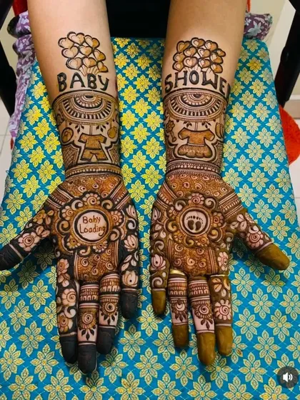 I love creating special mehandi for baby showers. This design features "Baby Shower" text, cute motifs like a teddy bear and baby feet, and a "Baby Loading" message on the palm for the mom-to-be.