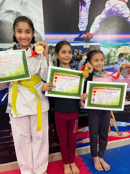 Three of our proud students displaying their medals and certificates. Each one represents hours of dedication and a commitment to excellence.