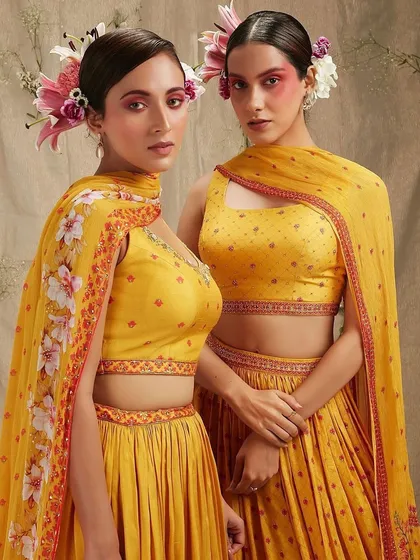 An editorial beauty look for Three Three Store featuring bold, artistic blush placement and floral hair accessories. The makeup is conceptual, using color blocking on the cheeks to create a unique, high-fashion statement.