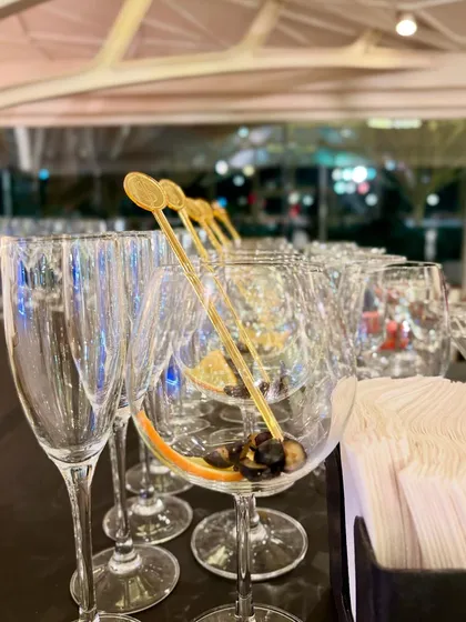 Elegant gold stirrers and pre-garnished glasses waiting for the party to begin. We ensure every element on our bar is beautifully prepared and presented.